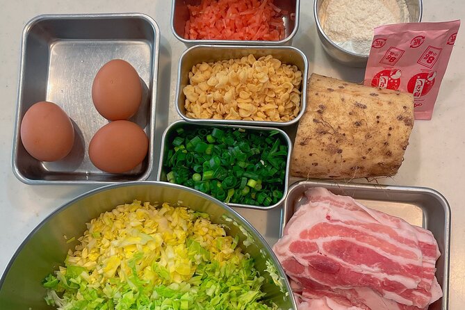 Small-Group Osaka-Style Okonomiyaki Cooking Class - The savory wait: pork and kimchi while yours cooks
