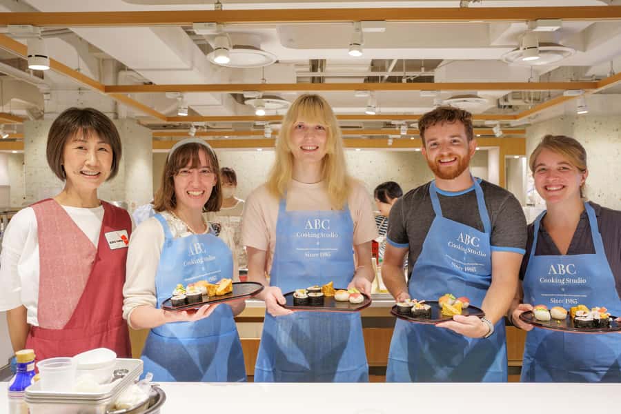 Tokyo: Tsukiji Market Walking Tour & Sushi Cooking Class - From Tsukiji Honganji Temple to the stalls: a guided market walk that keeps you moving